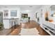 Bright living room with hardwood floors, kitchen access, and sleek, modern design elements at 312 Palencia Pl, Lakeland, FL 33803