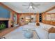 Bright living room with a brick fireplace, wood paneling, and a plush white sectional at 312 Palencia Pl, Lakeland, FL 33803