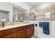 Well-lit bathroom featuring double sinks, granite counters, and a tiled shower with seamless glass at 3136 Langdon Ln, Winter Haven, FL 33884