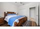 Comfortable bedroom with a wooden bed frame, complemented by a ceiling fan and closet for storage at 3136 Langdon Ln, Winter Haven, FL 33884