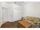 Bright bonus room with a sofa, side tables, dark wood flooring and closet space at 3136 Langdon Ln, Winter Haven, FL 33884