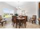 Formal dining room with elegant chandelier, a large window, and ample seating at 3136 Langdon Ln, Winter Haven, FL 33884