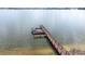 Aerial image of a dock with a boat on a calm lake at 3136 Langdon Ln, Winter Haven, FL 33884