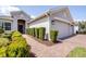 Inviting walkway of a single Gathering home leads to a front entrance with manicured greenery at 3136 Langdon Ln, Winter Haven, FL 33884