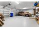 Spacious garage with a car, shelving, and dual overhead doors offers ample room for parking and storage at 3136 Langdon Ln, Winter Haven, FL 33884