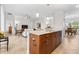 Large kitchen island with sink and storage, overlooking the living and dining areas at 3136 Langdon Ln, Winter Haven, FL 33884