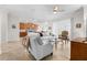 Bright living room with tile floors, ceiling fan, white couches and views into kitchen and dining areas at 3136 Langdon Ln, Winter Haven, FL 33884