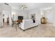 Cozy living room with neutral tones, tile floors, ceiling fan and view into the dining and Gathering room at 3136 Langdon Ln, Winter Haven, FL 33884