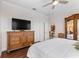 Comfortable main bedroom with a large TV, wood floors, and plenty of closet space at 3136 Langdon Ln, Winter Haven, FL 33884