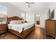 Serene bedroom featuring a large bed, wood floors, and access to an en-suite bathroom at 3136 Langdon Ln, Winter Haven, FL 33884