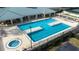 An aerial view of a neighborhood pool with an attached hot tub surrounded by lounge chairs at 3136 Langdon Ln, Winter Haven, FL 33884