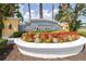 Welcoming community entrance sign surrounded by colorful flowers and lush landscaping at 3136 Langdon Ln, Winter Haven, FL 33884
