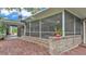 Spacious screened back porch features brick stairs and columns, ideal for outdoor living at 323 E Belvedere St, Lakeland, FL 33803