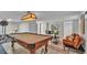 Finished basement with a pool table, workout area and a cozy seating area for leisure at 323 E Belvedere St, Lakeland, FL 33803