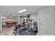 Basement workout area featuring weight rack and bench, alongside a pool table for entertainment at 323 E Belvedere St, Lakeland, FL 33803