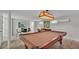 Finished basement featuring a pool table, seating area, and a unique vintage Gators light fixture at 323 E Belvedere St, Lakeland, FL 33803