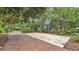 Outdoor basketball court surrounded by lush greenery and brick pathway for active recreation at 323 E Belvedere St, Lakeland, FL 33803