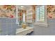Charming bathroom vanity featuring classic blue tiling, decorative shelves, and floral accents at 323 E Belvedere St, Lakeland, FL 33803