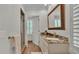 Bathroom with a granite countertop, decorative mirror, and glass shower at 323 E Belvedere St, Lakeland, FL 33803