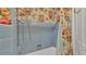 Classic bathroom with blue tile and floral shower curtain, evoking a vintage charm at 323 E Belvedere St, Lakeland, FL 33803