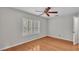 Bright bedroom featuring wood floors, a ceiling fan, and natural light from the window at 323 E Belvedere St, Lakeland, FL 33803