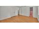 Bright bedroom with hardwood floors and ensuite pink and black checkered bathroom at 323 E Belvedere St, Lakeland, FL 33803