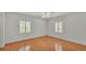 Bedroom with hardwood floors, a ceiling fan, and large windows with shutters at 323 E Belvedere St, Lakeland, FL 33803
