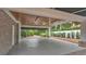 Spacious carport featuring a wood-paneled ceiling with lighting, and ample space for parking and storage at 323 E Belvedere St, Lakeland, FL 33803