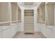 A walk-in closet with custom shelving and drawers provides ample storage space at 323 E Belvedere St, Lakeland, FL 33803