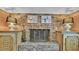 Close up of a brick fireplace, complete with vintage decor, flanked by decorative side tables at 323 E Belvedere St, Lakeland, FL 33803