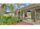 Inviting front entrance with brick path and lush landscaping, showcasing a charming and welcoming home at 323 E Belvedere St, Lakeland, FL 33803
