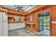 Functional garage interior with wood paneling, built-in shelving, and a workbench at 323 E Belvedere St, Lakeland, FL 33803