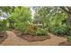 Lush garden with brick paths, mature trees, and vibrant plantings, creating a serene outdoor oasis at 323 E Belvedere St, Lakeland, FL 33803