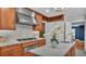 Modern kitchen featuring stainless steel cooktop and white countertops on center island with cabinetry at 323 E Belvedere St, Lakeland, FL 33803