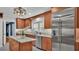 Kitchen featuring stainless steel refrigerator, adjacent to a kitchen island and a sink under a window at 323 E Belvedere St, Lakeland, FL 33803