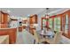 Bright, open kitchen with warm wood cabinets, stainless appliances and a connected breakfast nook at 323 E Belvedere St, Lakeland, FL 33803