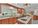 Bright kitchen with stainless steel appliances, white countertops, a kitchen island and a sink under a window at 323 E Belvedere St, Lakeland, FL 33803