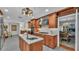 Spacious open kitchen with a center island cooktop, stainless appliances, and an adjacent dining room at 323 E Belvedere St, Lakeland, FL 33803