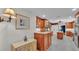Bright kitchen with stainless steel appliances, wood cabinets, and speckled floor at 323 E Belvedere St, Lakeland, FL 33803