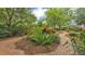 Beautiful backyard landscaping with brick walkways, colorful flowers, and lush greenery at 323 E Belvedere St, Lakeland, FL 33803