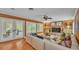 Bright living room with brick fireplace, access to outside, and hardwood floors at 323 E Belvedere St, Lakeland, FL 33803
