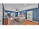 Spacious main bedroom featuring blue walls, hardwood floors, sitting area and fireplace at 323 E Belvedere St, Lakeland, FL 33803