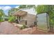 Outdoor kitchen with brick, a grill, prep area, and storage; nestled amongst lush greenery at 323 E Belvedere St, Lakeland, FL 33803
