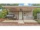 Outdoor kitchen with a brick structure, stainless steel counter, grill, and a smoke pit at 323 E Belvedere St, Lakeland, FL 33803