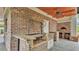 Outdoor kitchen with brickwork, pizza oven, and custom grilling station for elegant outdoor cooking at 323 E Belvedere St, Lakeland, FL 33803