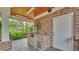 Covered outdoor kitchen features a brick design, custom grill, and ample counter space for meal preparation at 323 E Belvedere St, Lakeland, FL 33803