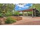 Outdoor patio with brick pavers, raised garden beds, and a covered pavilion for entertaining at 323 E Belvedere St, Lakeland, FL 33803