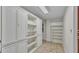 Spacious pantry room with ample storage in white cabinets and shelves, perfect for organization at 323 E Belvedere St, Lakeland, FL 33803