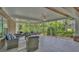 Spacious screened-in patio with outdoor seating and a serene view of the lush landscaping at 323 E Belvedere St, Lakeland, FL 33803