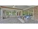 Inviting screened-in patio with comfortable seating and brick accents, perfect for relaxation and entertainment at 323 E Belvedere St, Lakeland, FL 33803